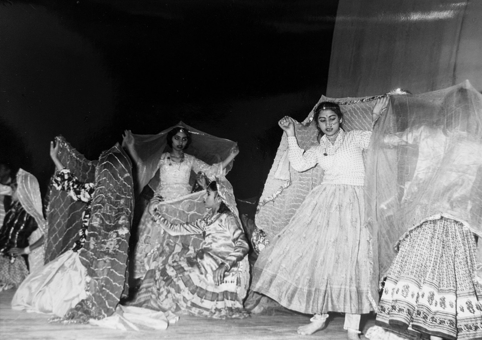 Girls performing a folk dance with veils held aloft at the annual function, 1970s-80s