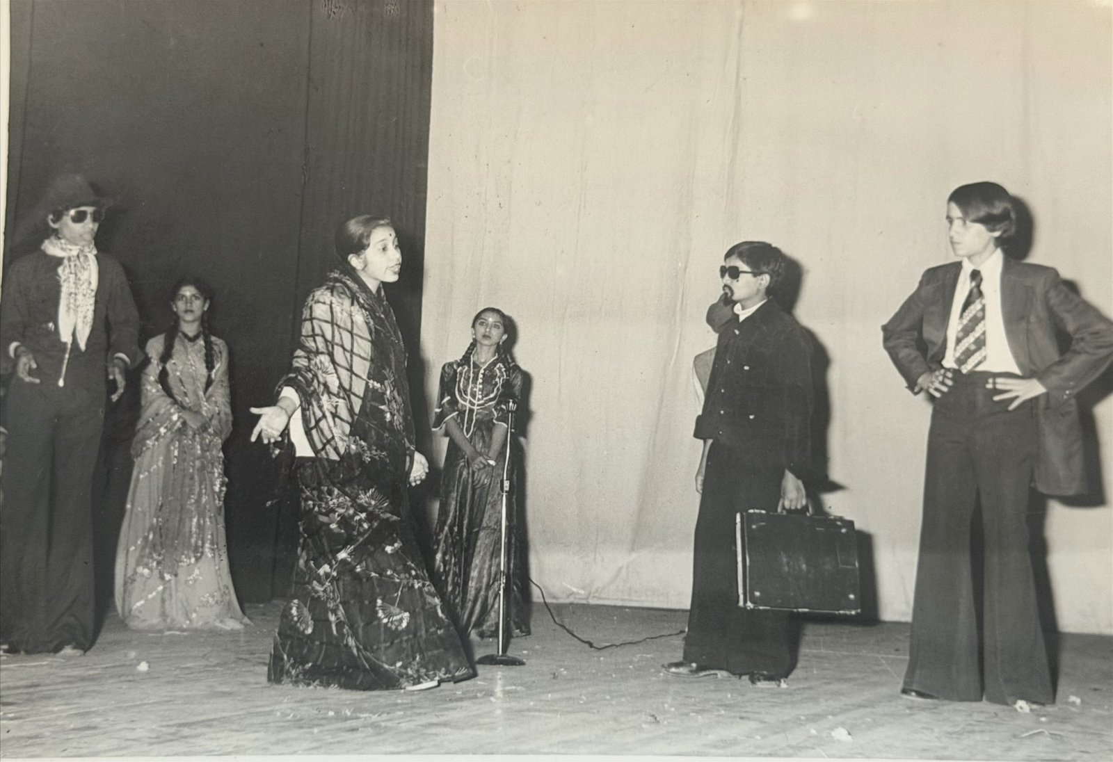 A school play in period costume on the annual-day stage, 1970s-80s