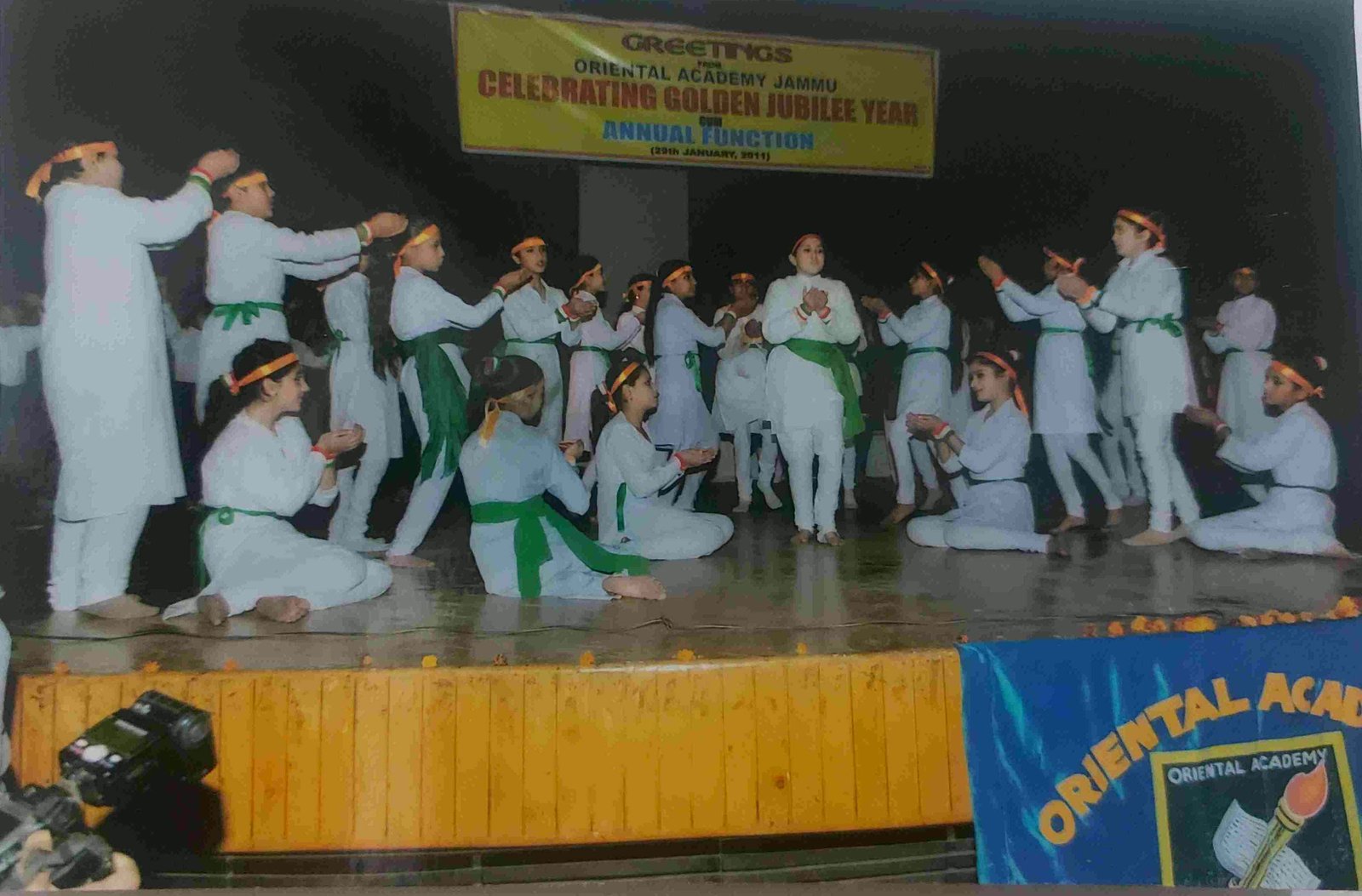 Children performing on stage beneath the Celebrating Golden Jubilee Year banner