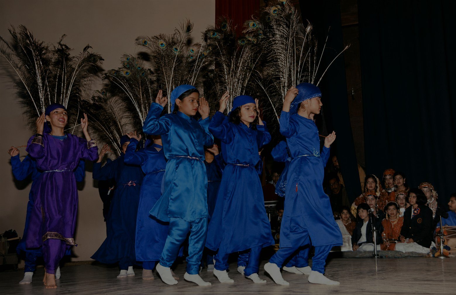 Students in costume performing on the Oriental Academy stage