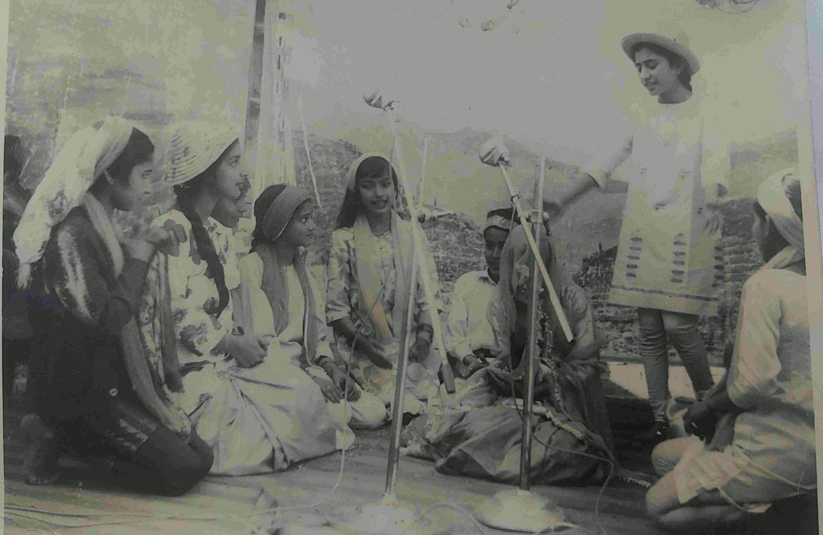 Children in costume seated on stage for a tableau at an early annual function