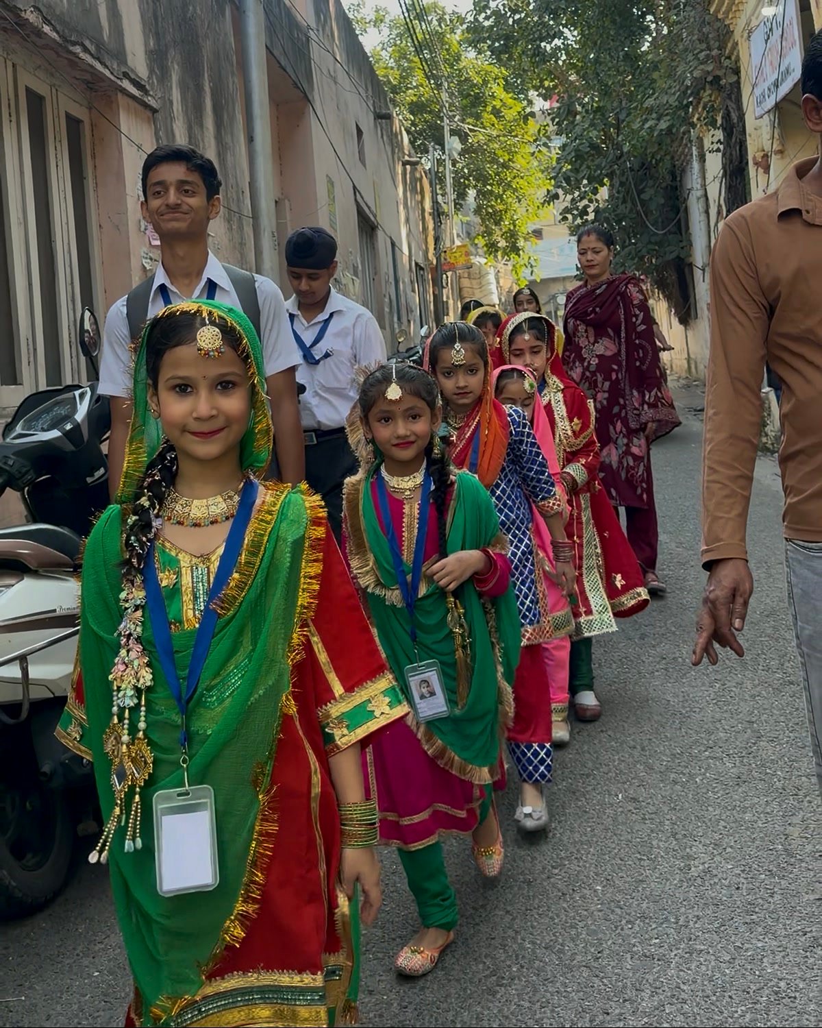 Young Oriental Academy students in Dogra dress walking to the venue