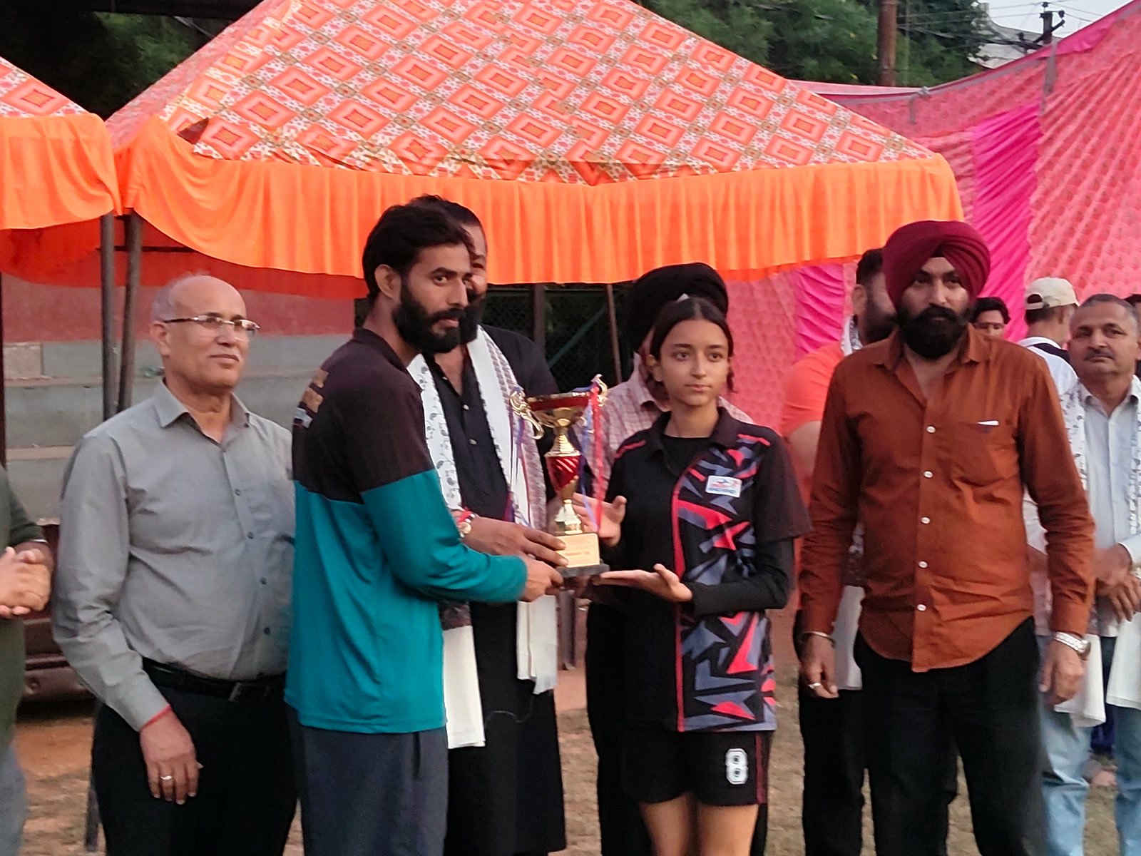 Girls' captain Ritishka receiving the runners-up trophy on the field