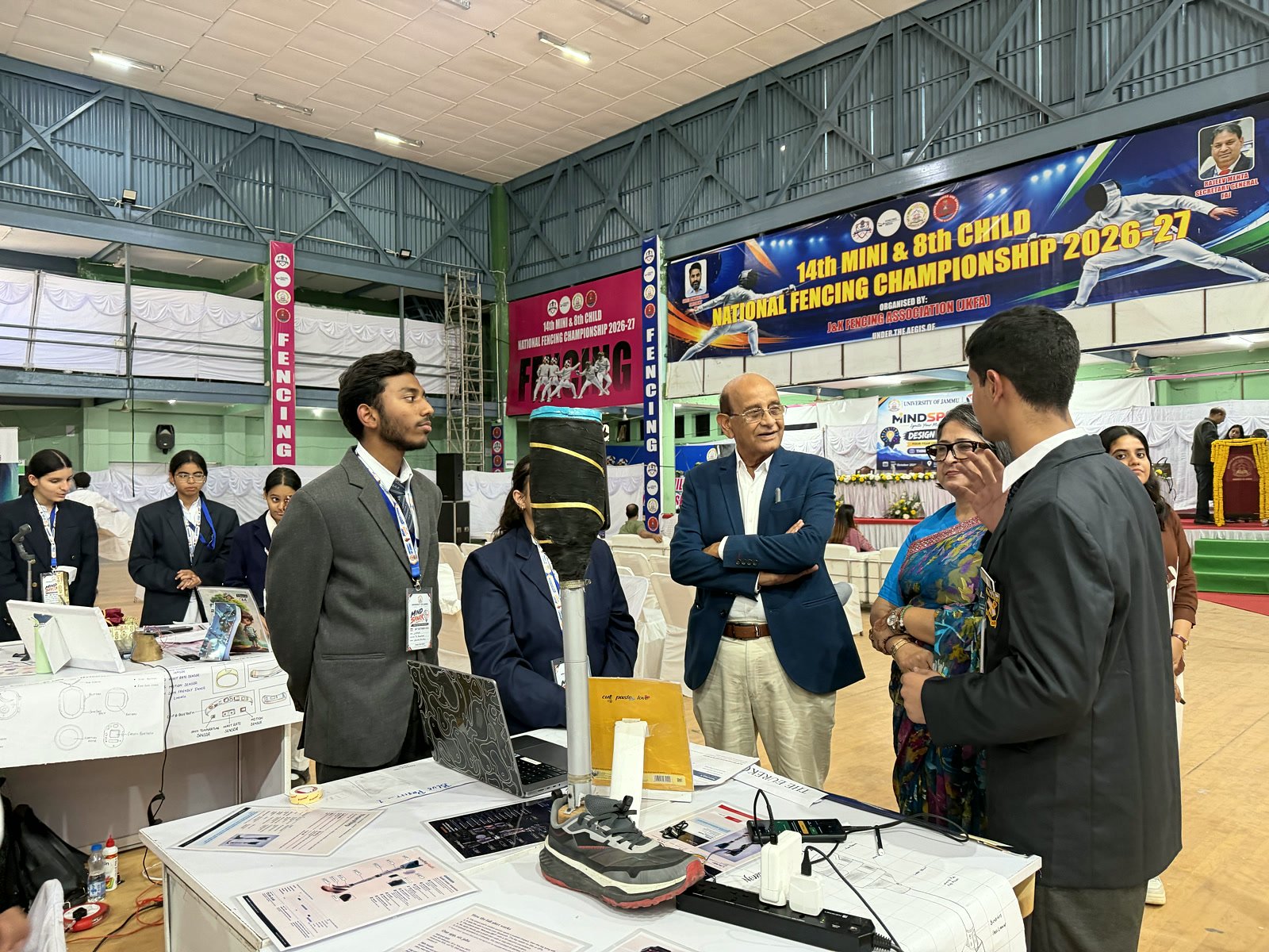 Guests listening to the NeuroStep team at their stall in the Gymnasium Hall