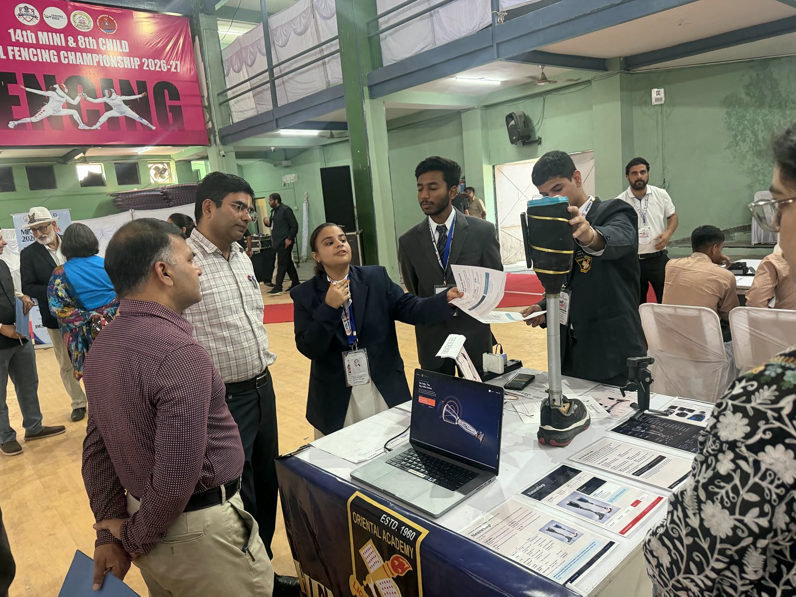 NeuroStep team members explaining the prosthetic leg to visitors at their stall
