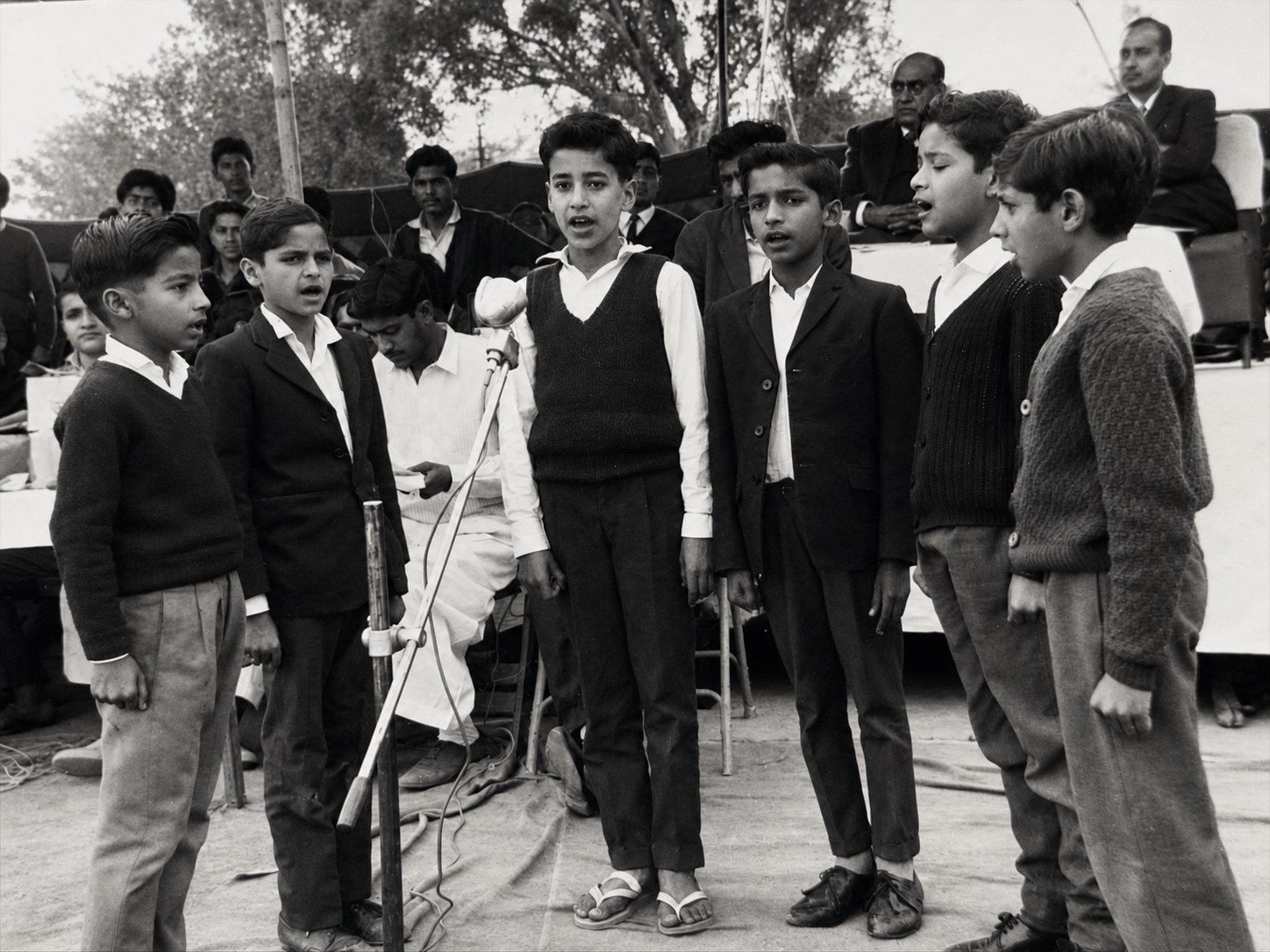 Boys singing into a microphone at the 1969 annual day