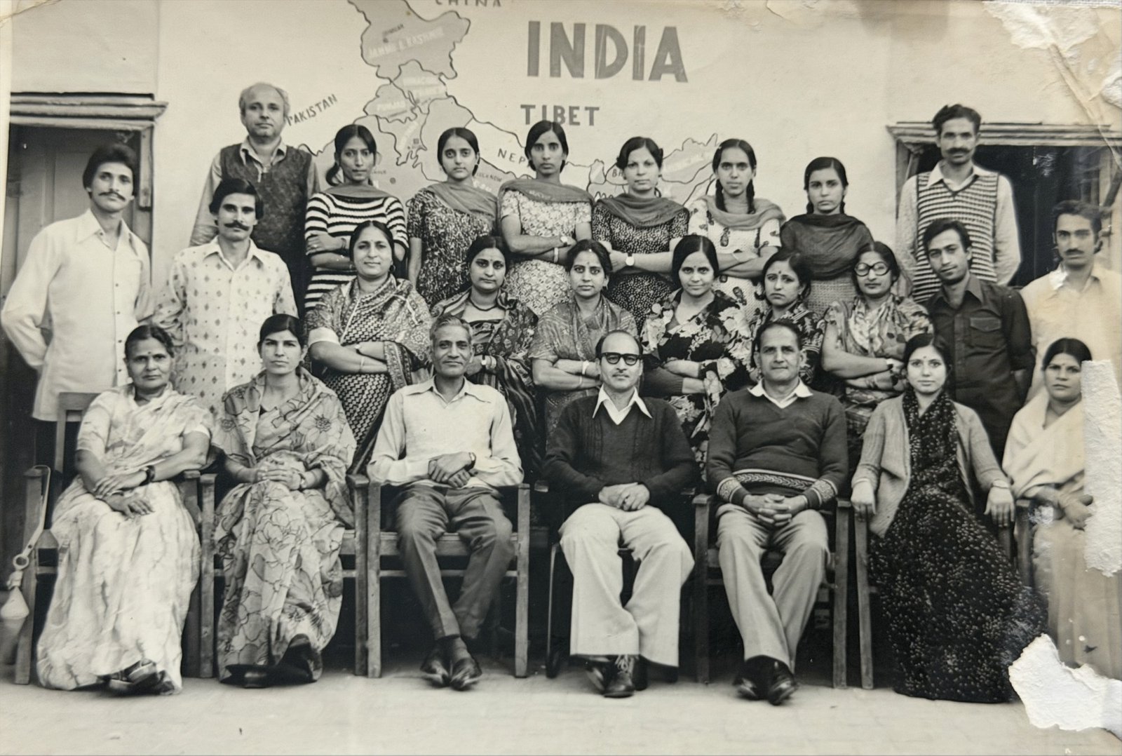The staff group of the 1970s before a hand-painted map of India