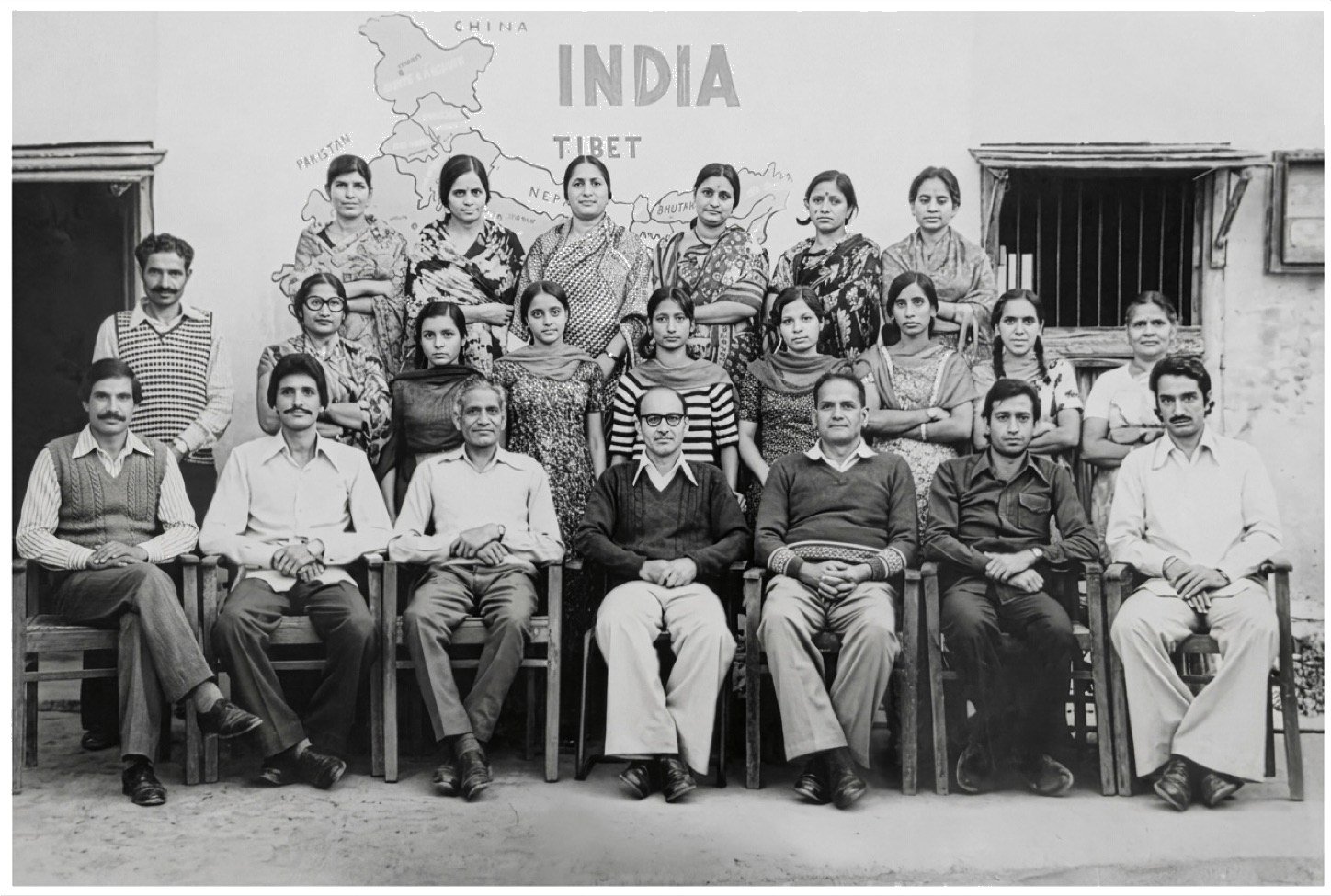 The staff of 1978 in front of a map of India
