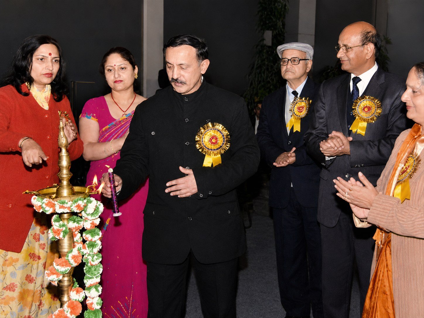 Principal Vivek Prakash Chauhan lighting the ceremonial lamp as the founder and staff look on