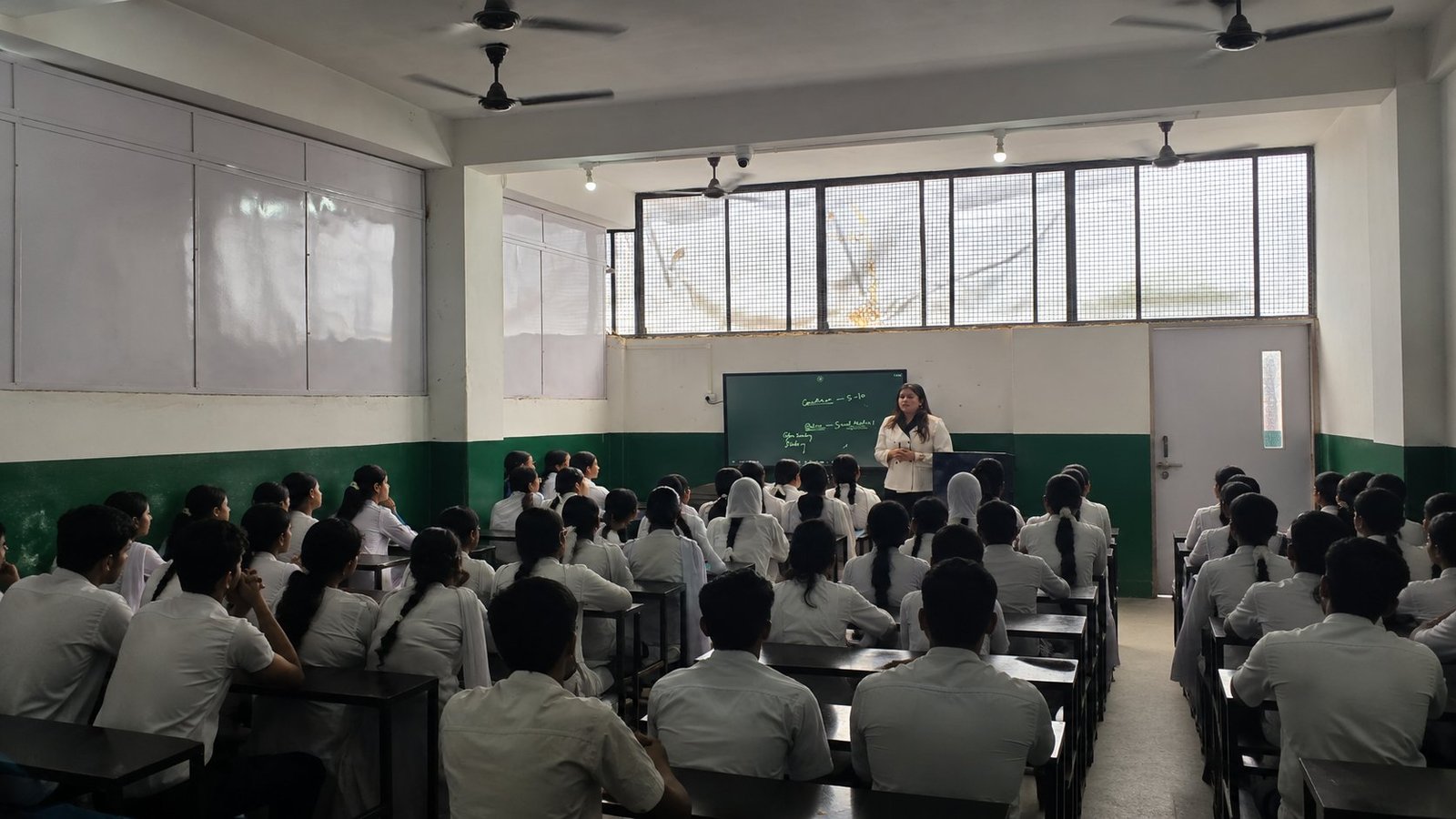 A senior classroom today: the teacher at the board, every bench full