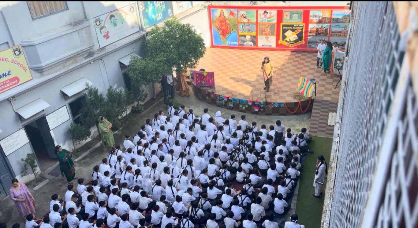 The school ground seen from above, the whole school gathered at assembly